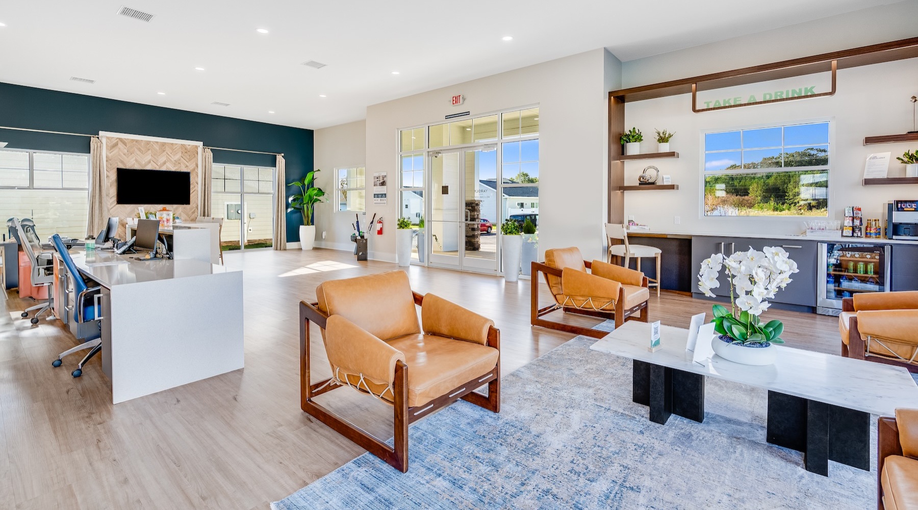 a clubroom with a tv, tables and chairs