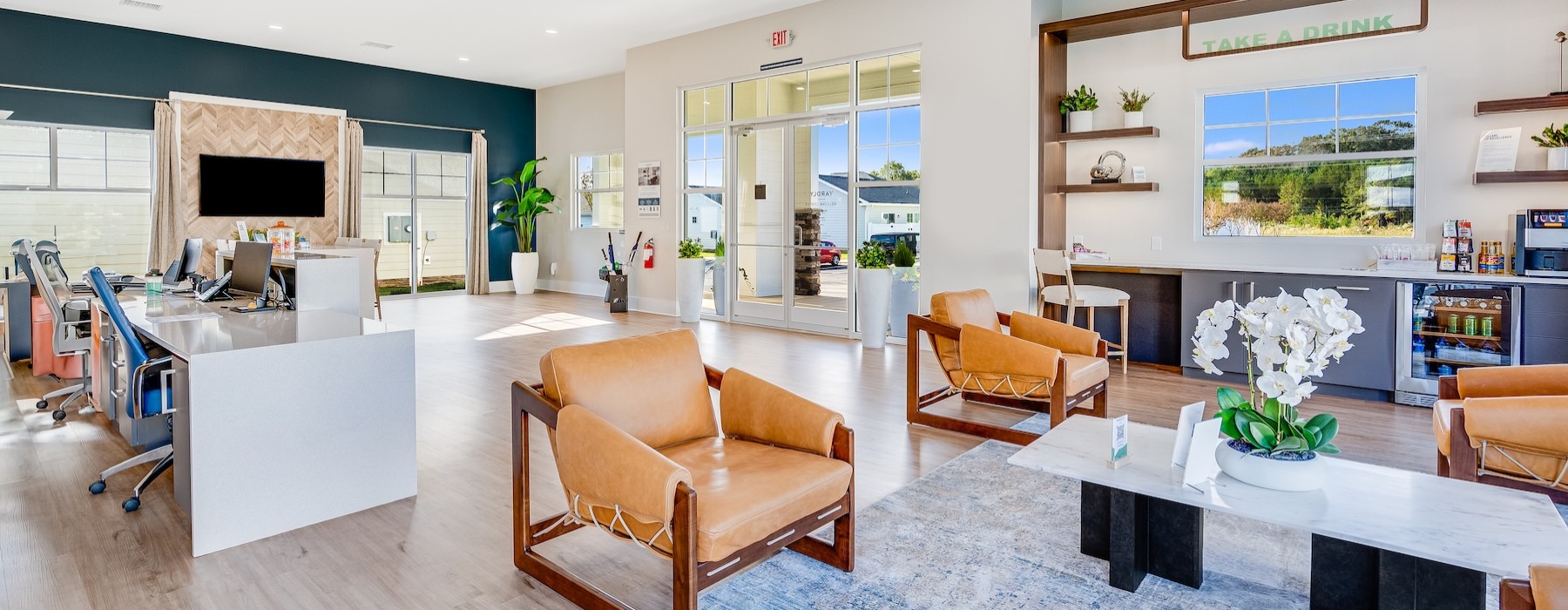 a clubroom with a tv, tables and chairs