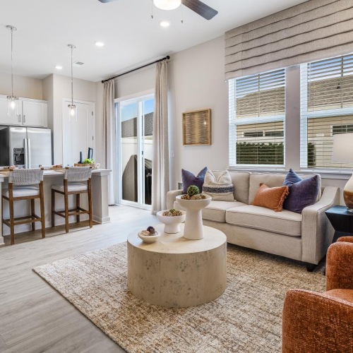 a living room with a couch, chairs and a tv