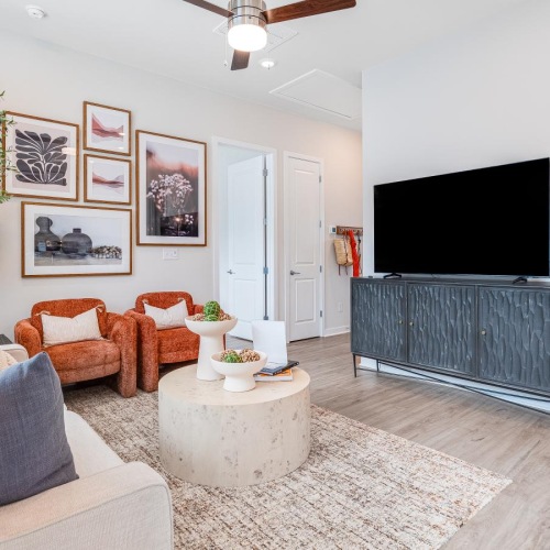 a living room with a tv and couches
